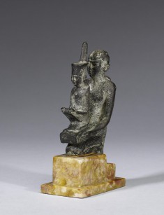 Priest Holding a Statue of the Goddess Neith