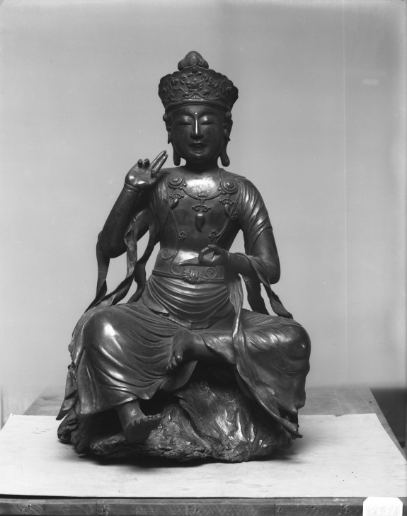 Buddha seated on gnarled tree-trunk base