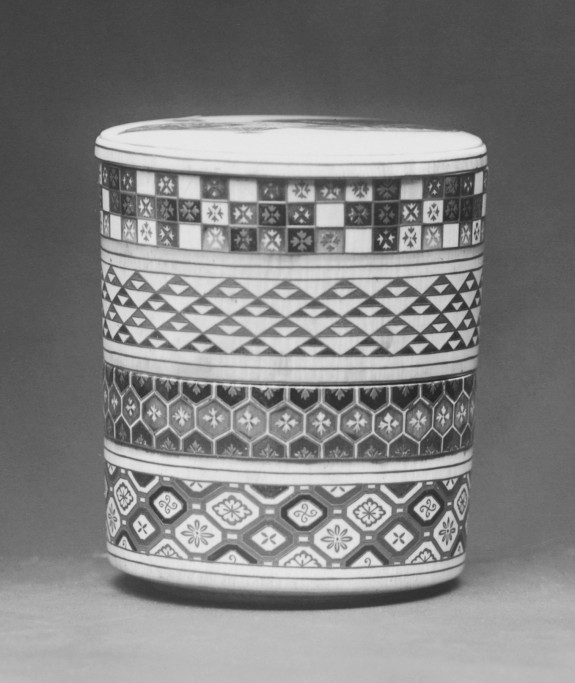 Cylindrical container lacquered with textile patterns; two fans on the lid with falling cherry blossoms