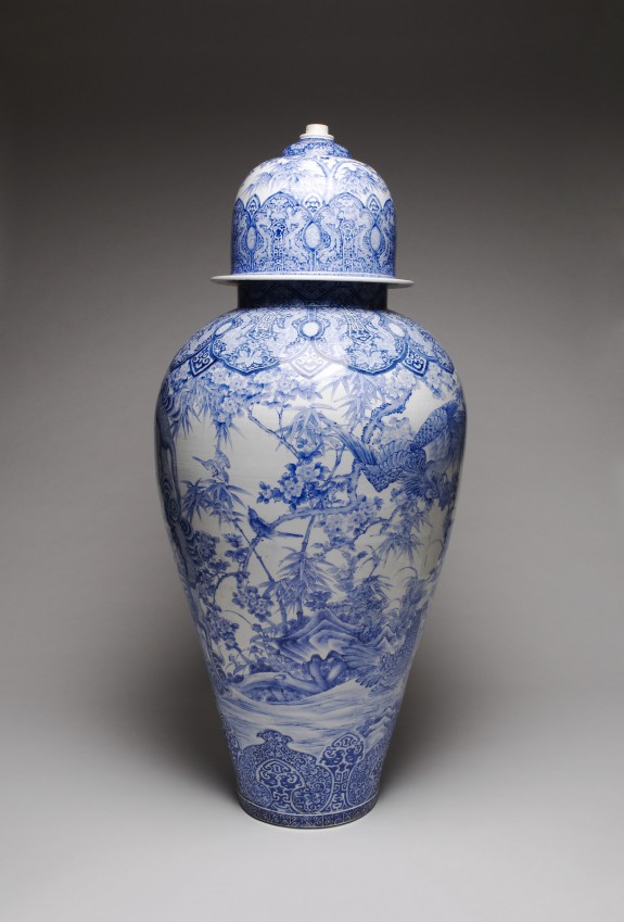 Arita Ware Covered Jar with a Panel Depicting a Collection of Antiques in a Chinese Garden