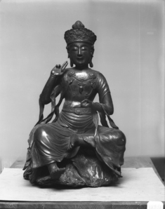 Image for Buddha seated on gnarled tree-trunk base