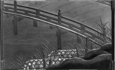 Writing table with bridge, reeds and stones