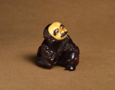 Netsuke of a Man Wearing a Mustached Mask