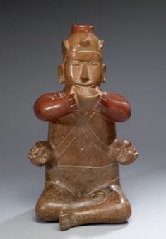 Seated Male with Trophy Heads
