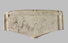 Relief Fragment with Male Figures Carrying Goats Before a Ruler