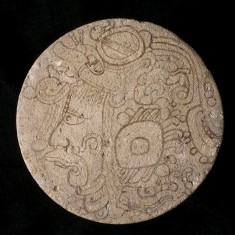 One of a Pair of Maya Painted Earflares with Profile Deity Heads