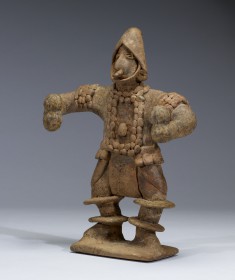 Standing Figure with Elaborate Costume Holding Rattles