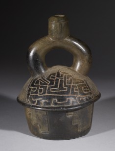 Stirrup spout vessel with supernatural being's head