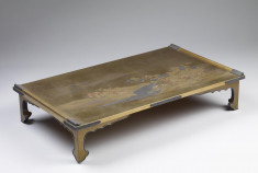 Writing table with brook and various flowers and mountains