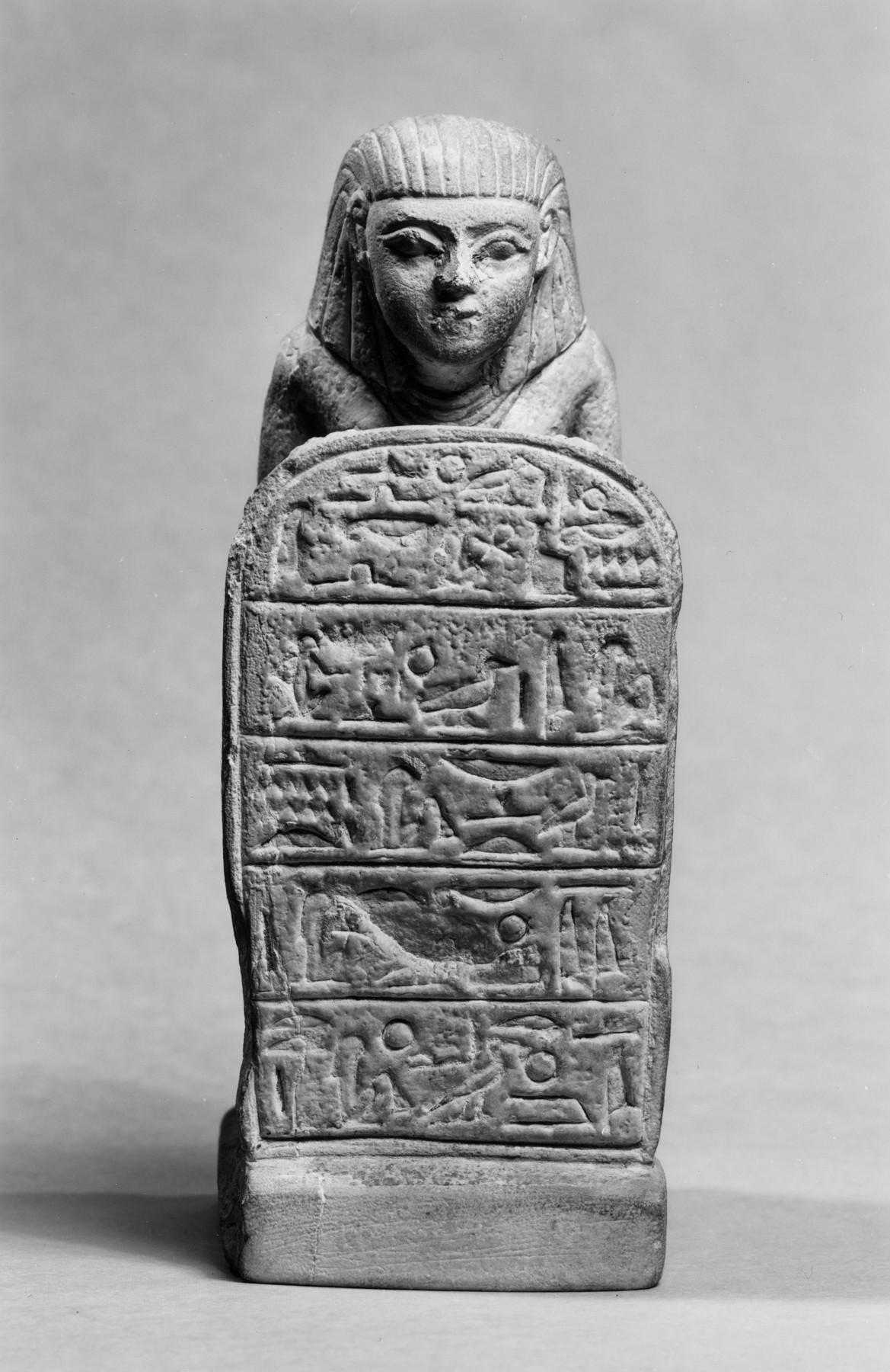 Kneeling Figure Holding a Stele