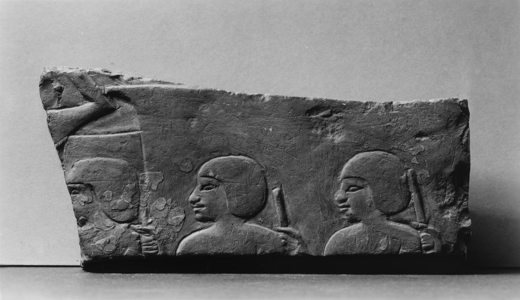 Wall Fragment with Enslaved Men Holding Staffs