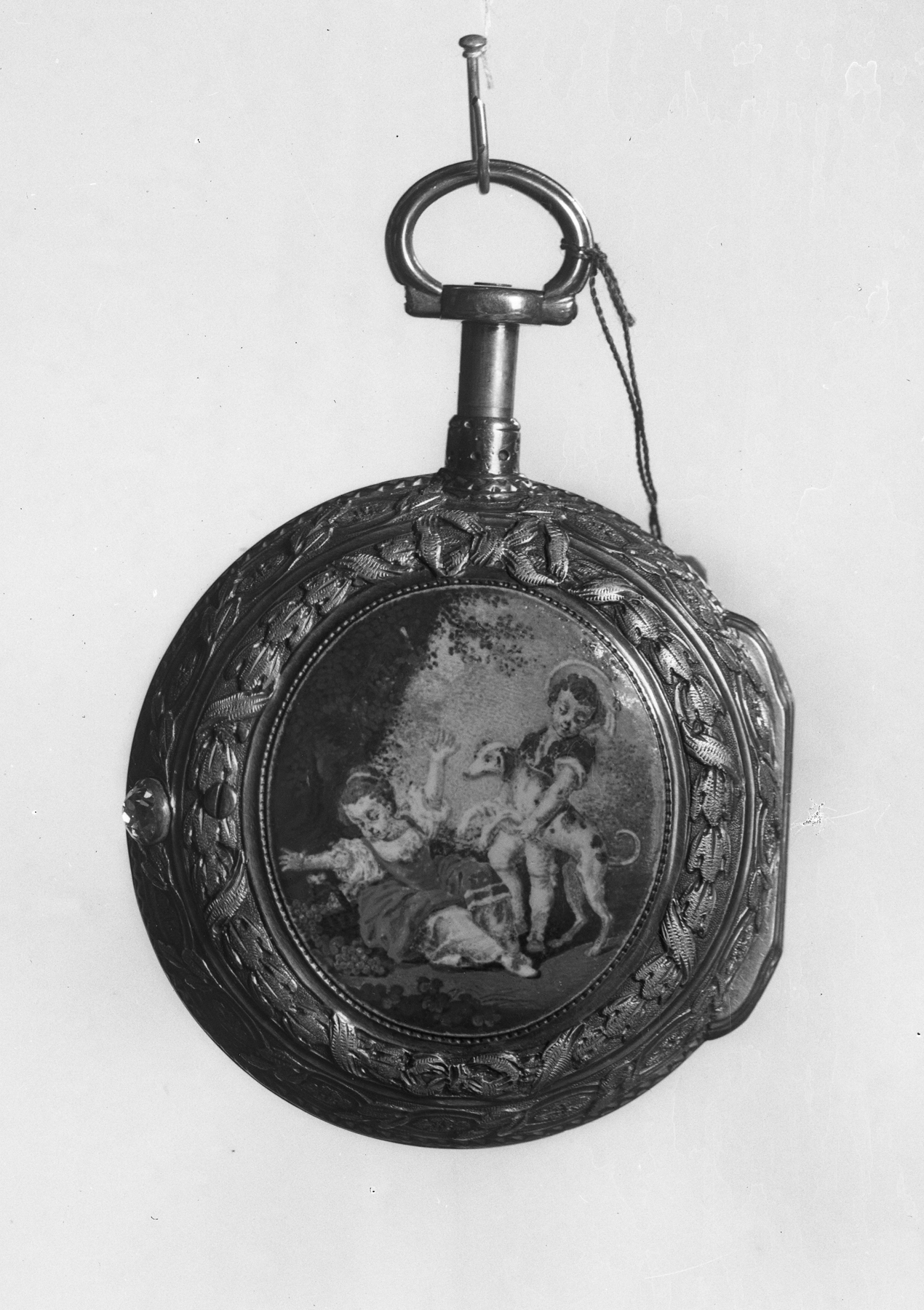 Watch with oval medallion of a boy and girl playing with a dog